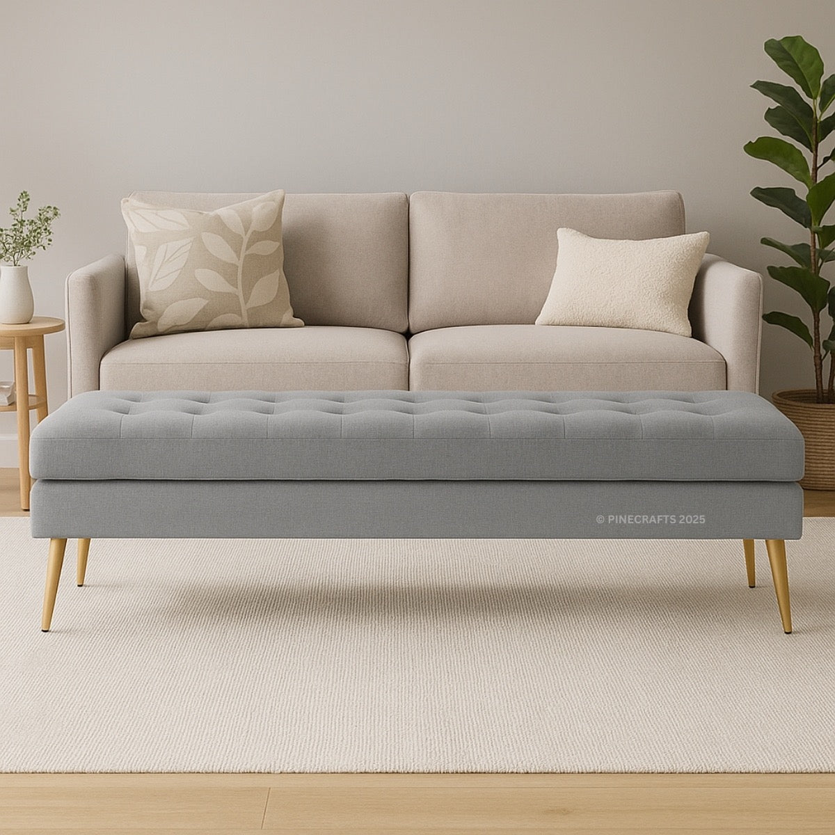 Gray tufted bench in front of a beige sofa with decorative pillows in a room setting.
