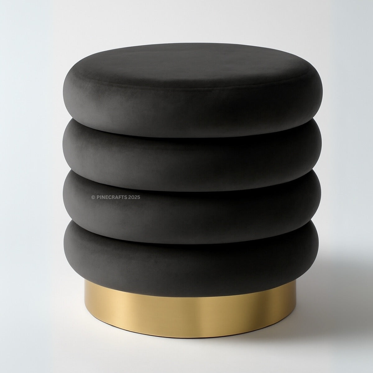 Black ottoman with gold base on a white background