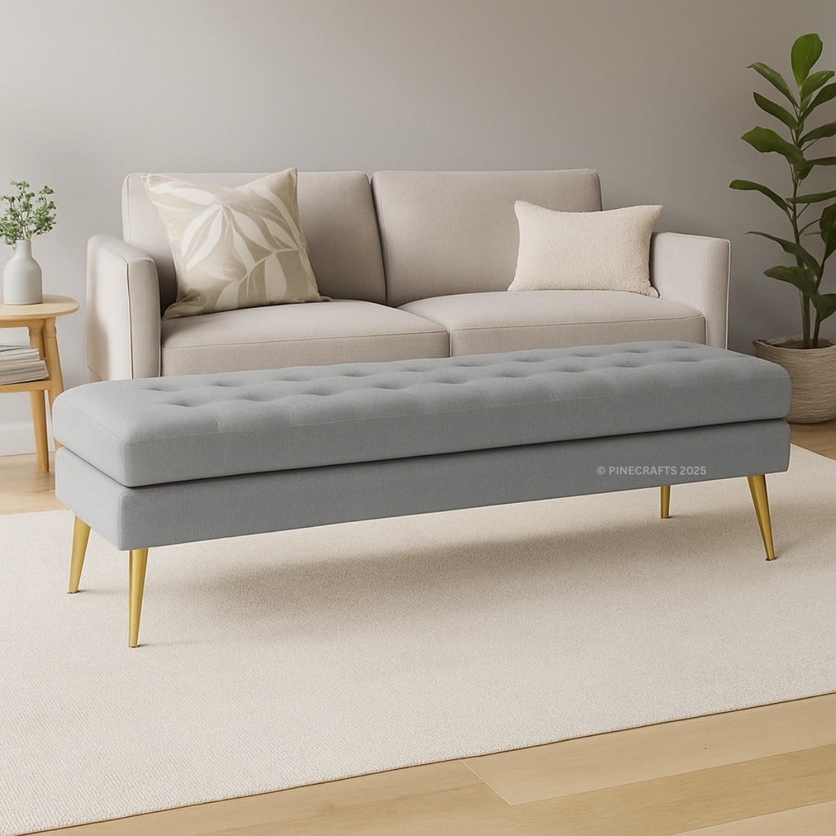Gray tufted bench in front of a beige sofa with decorative pillows on a light wood floor.