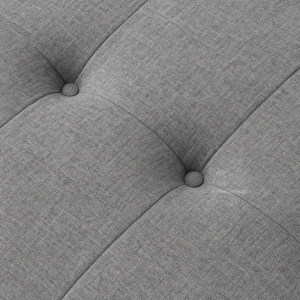 Close-up of a gray upholstered chair with tufted design