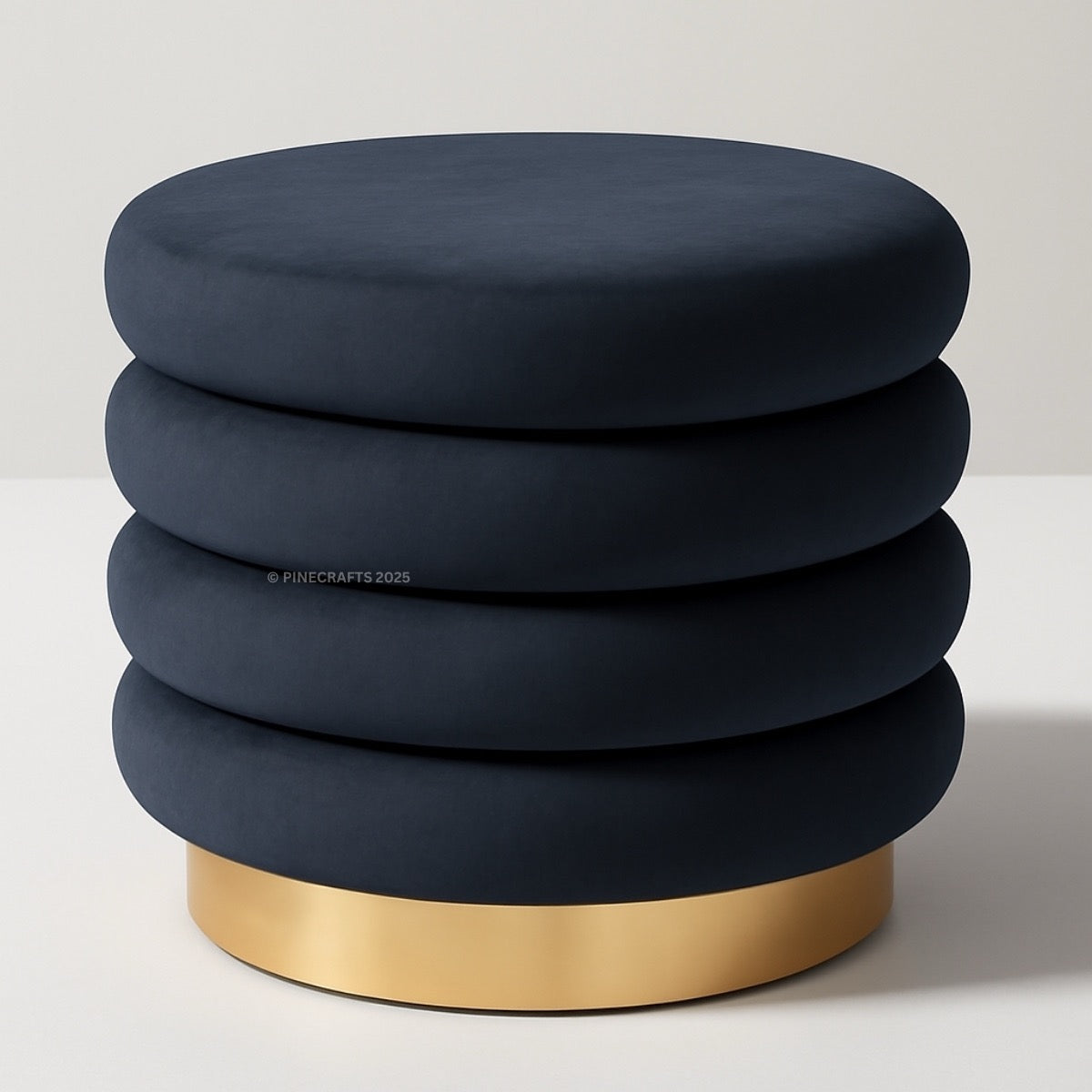 Stack of navy blue cushions with a gold base on a light gray background