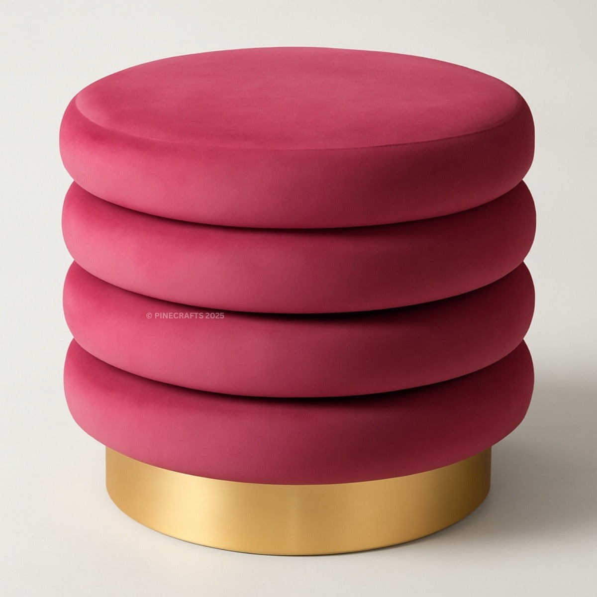 Pink ottoman with a gold base on a white background