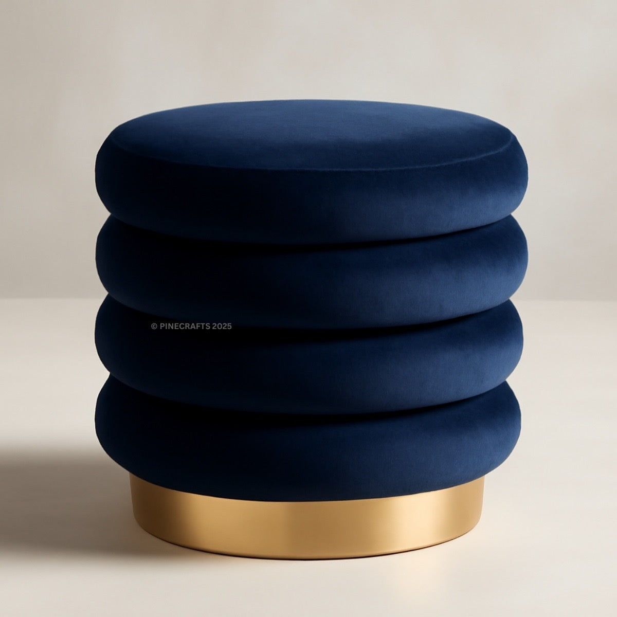 Blue ottoman with gold base on a light background