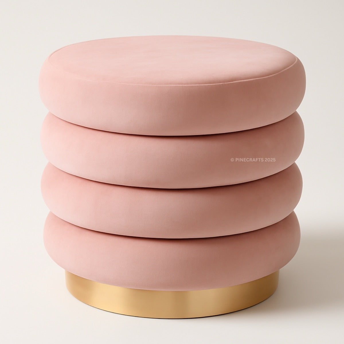 Pink ottoman with a gold base on a light background