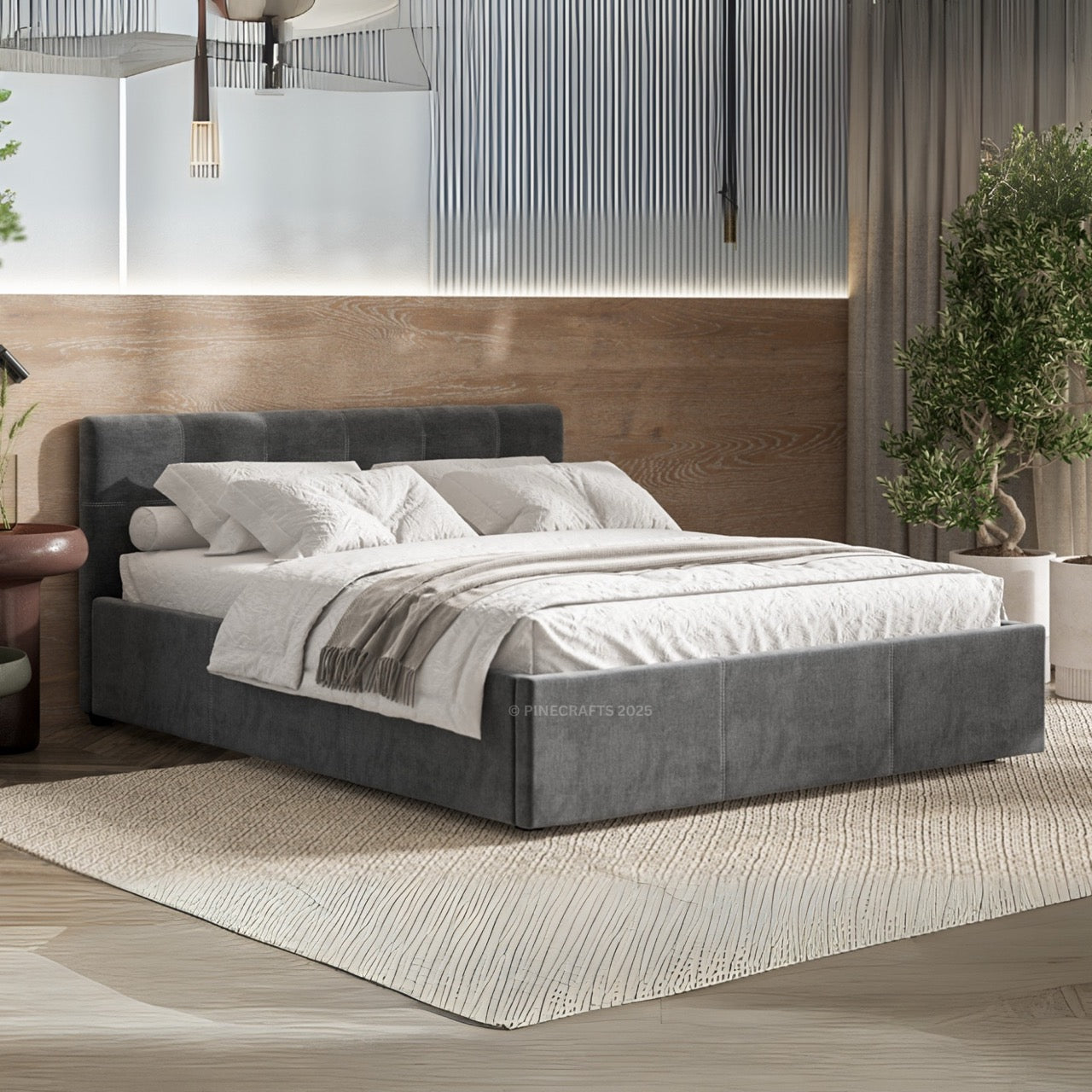 Gray upholstered bed in a modern bedroom setting with wooden headboard and plants.