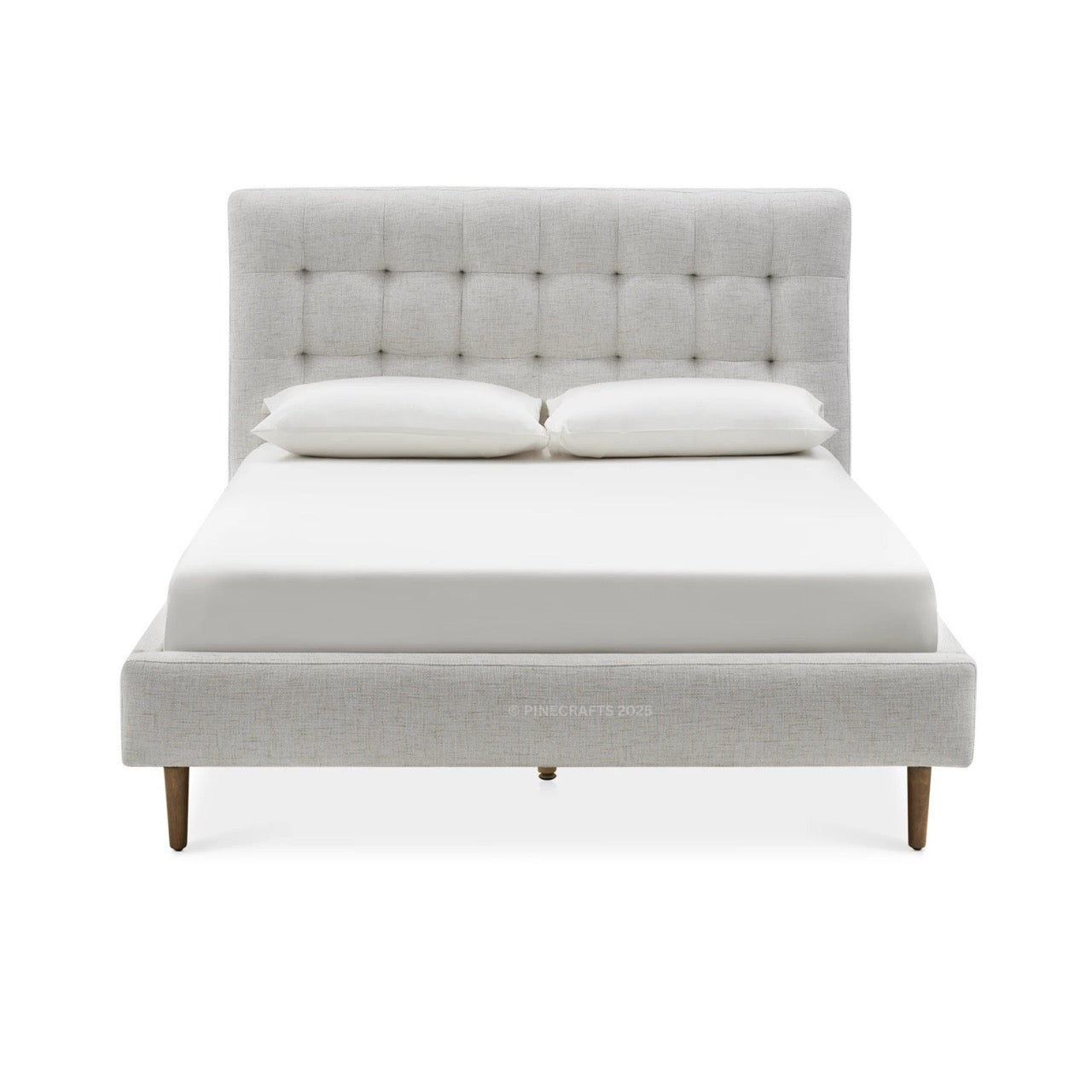 Gray upholstered bed with white bedding on a white background