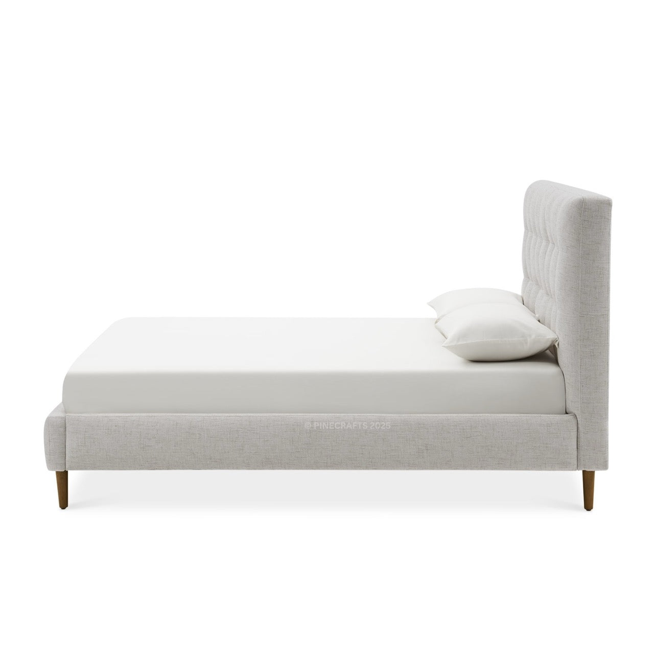 Gray upholstered bed with a white pillow on a white background