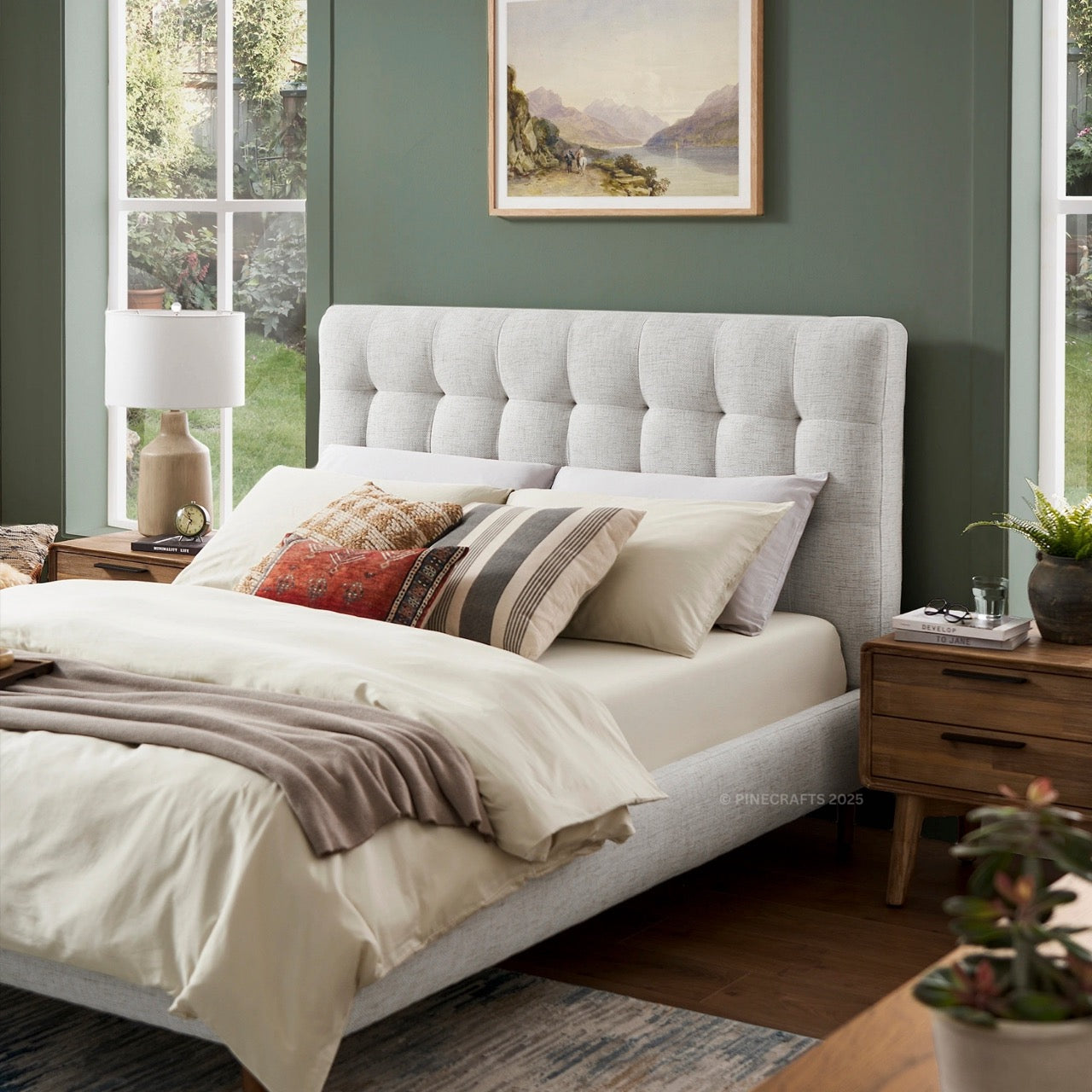 Neatly made bed with decorative pillows in a bedroom setting.