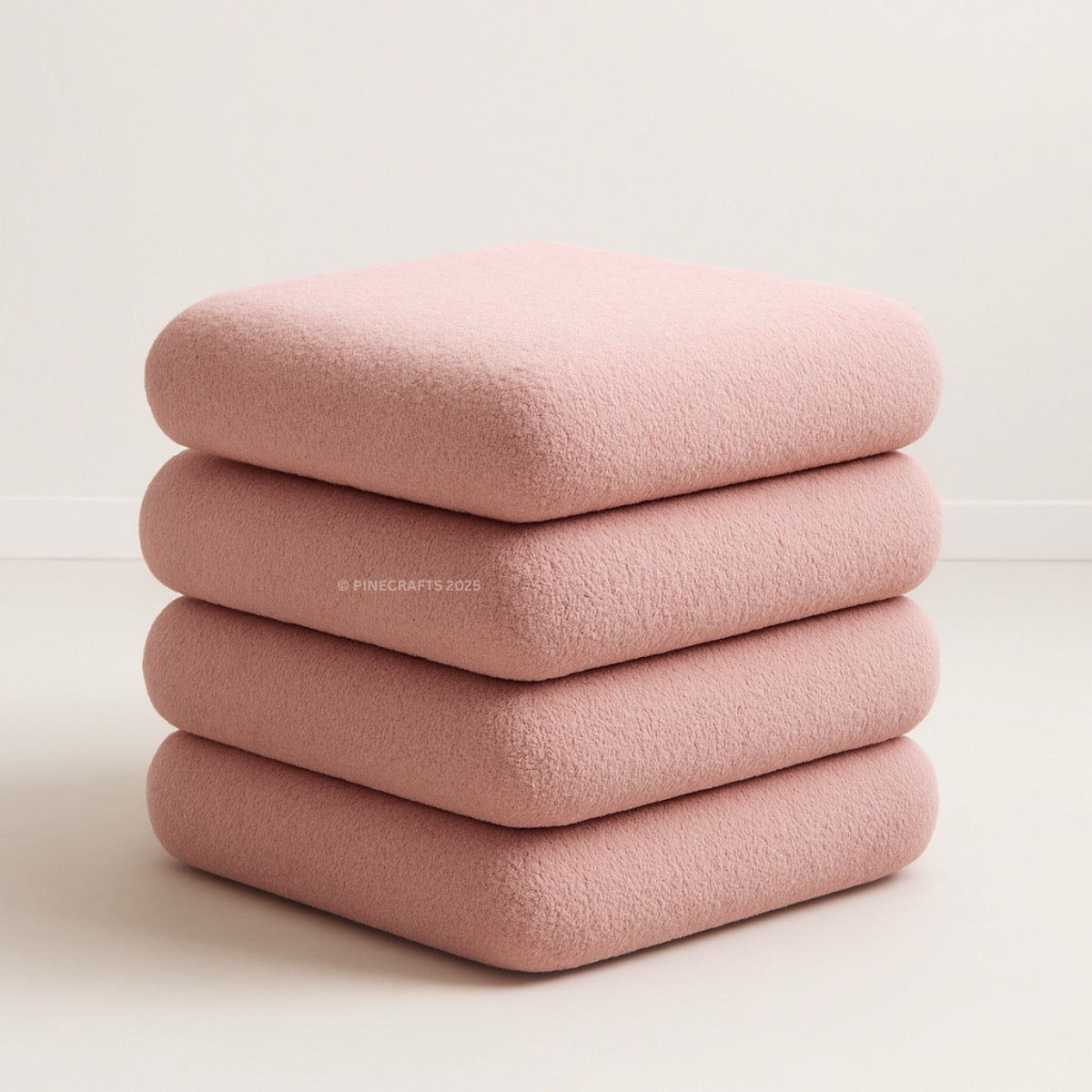 Stack of pink folded blankets on a light beige background