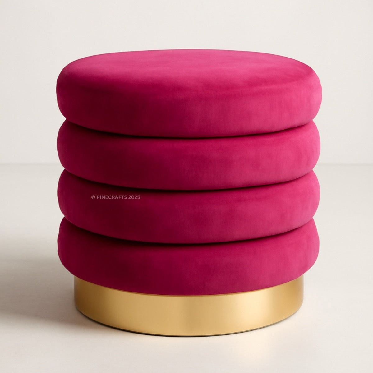 Pink ottoman with gold base on a light background