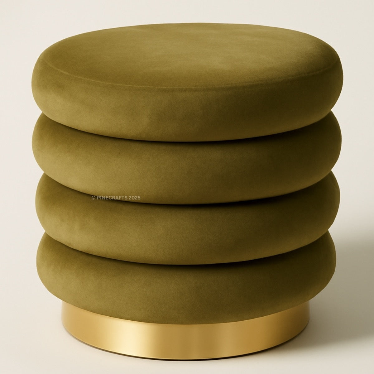 Green ottoman with a gold base on a beige background