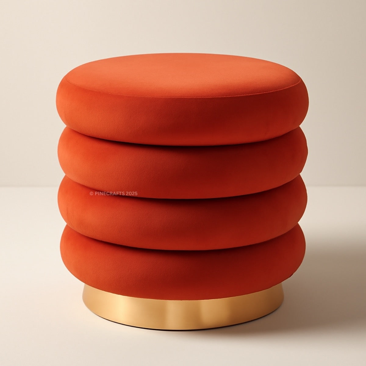 Stacked red ottomans with a gold base on a beige background