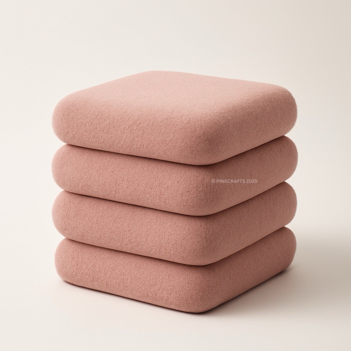 Stack of four pink cushions on a light beige background