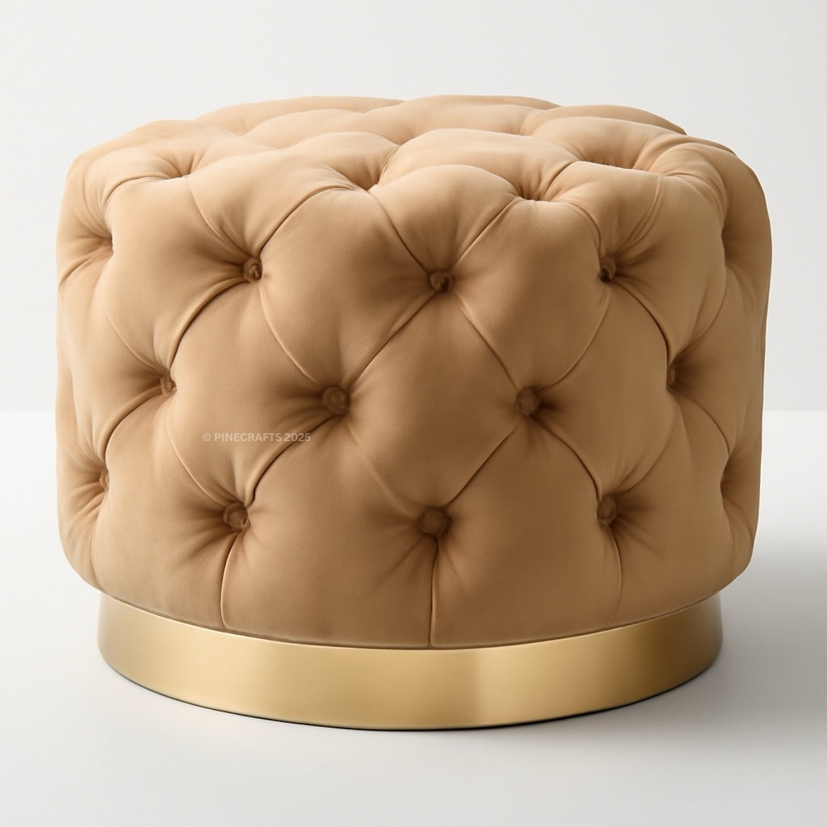 Beige tufted ottoman with a gold base on a white background