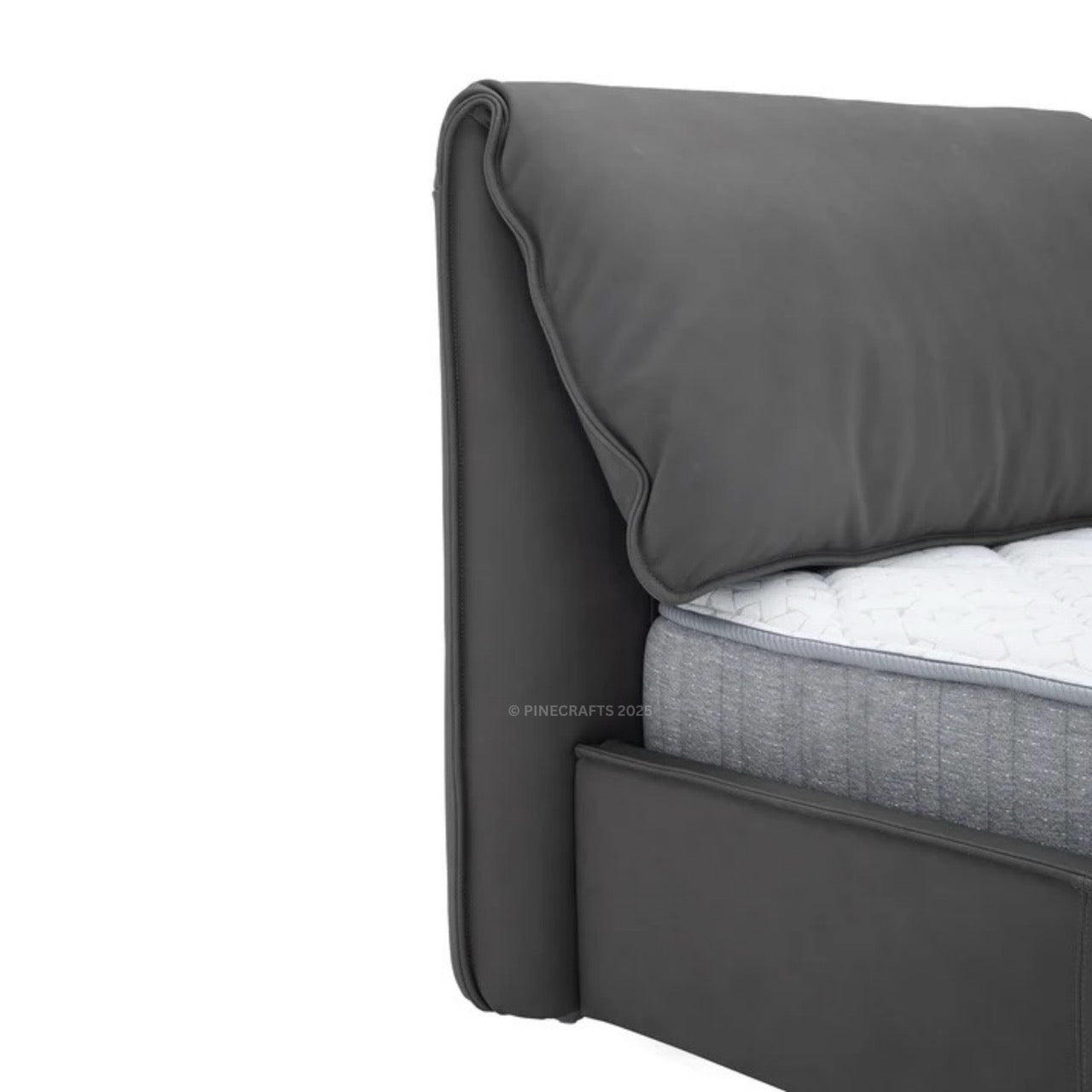Gray upholstered bed with a pillow on a white background