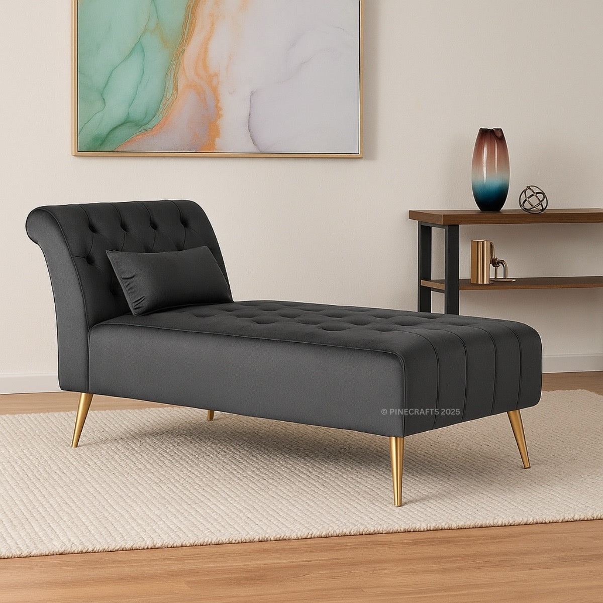 Gray tufted chaise lounge with gold legs in a room setting.