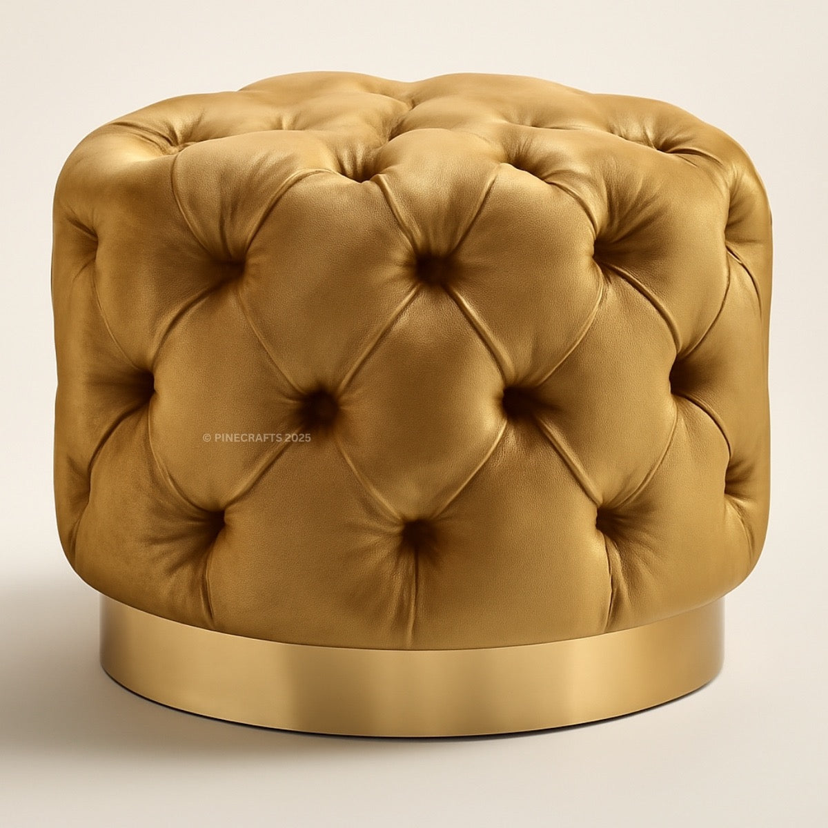 Gold tufted ottoman on a beige background