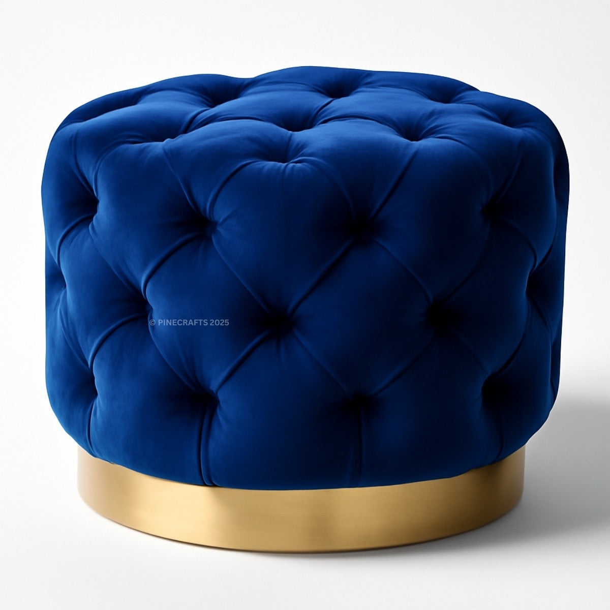 Blue tufted ottoman with a gold base on a white background