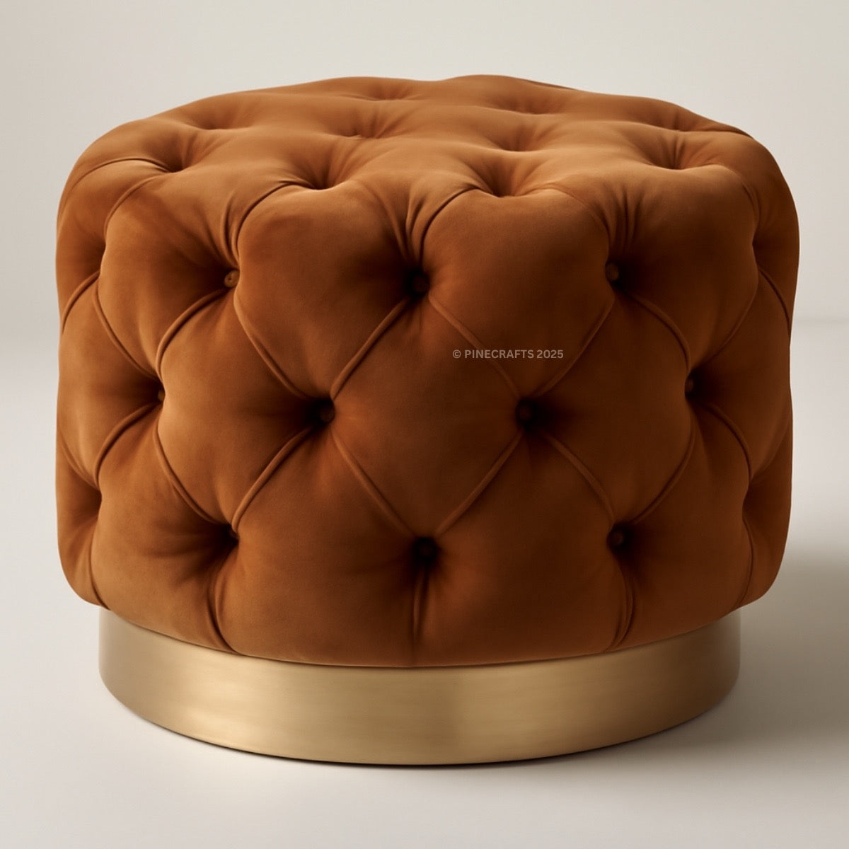 Brown tufted ottoman with a gold base on a neutral background