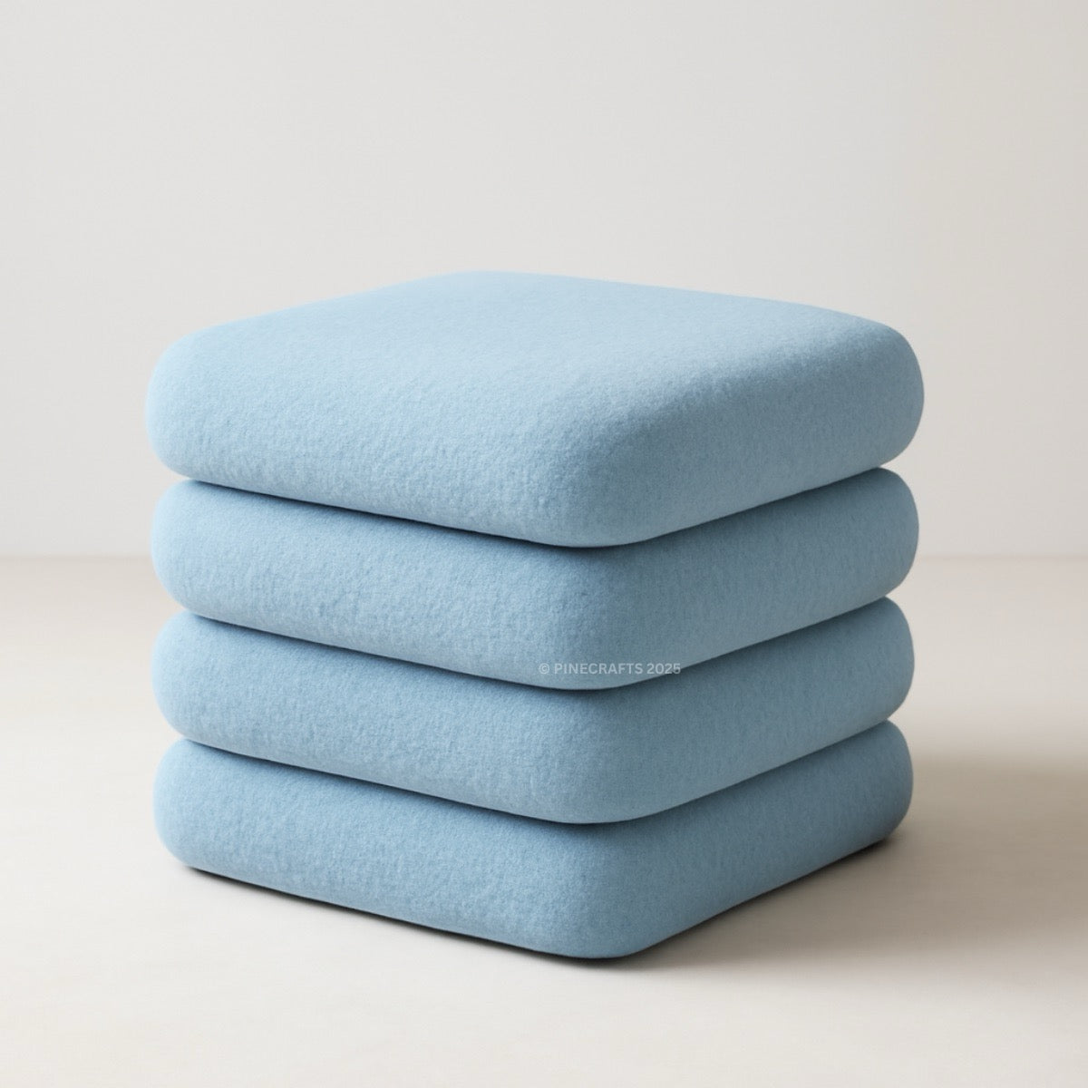 Stack of light blue cushions on a neutral background