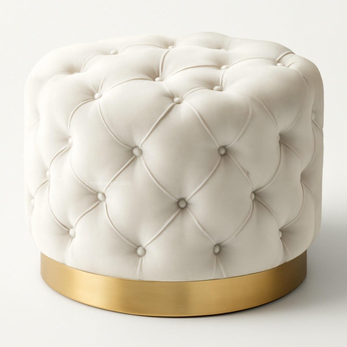 White tufted ottoman with a gold base on a white background