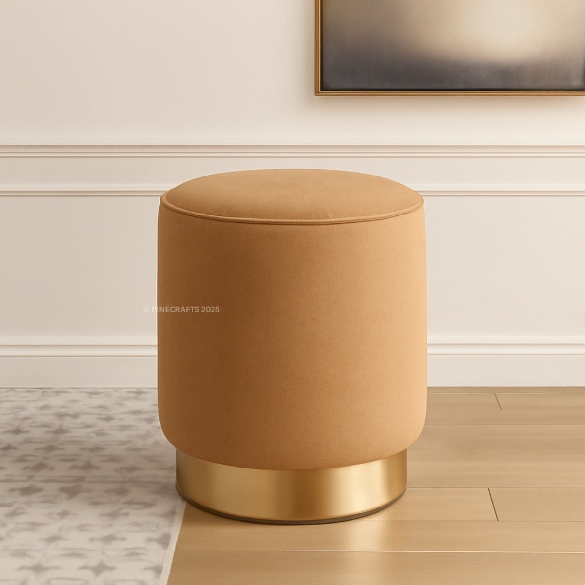 Brown ottoman with gold base on a wooden floor