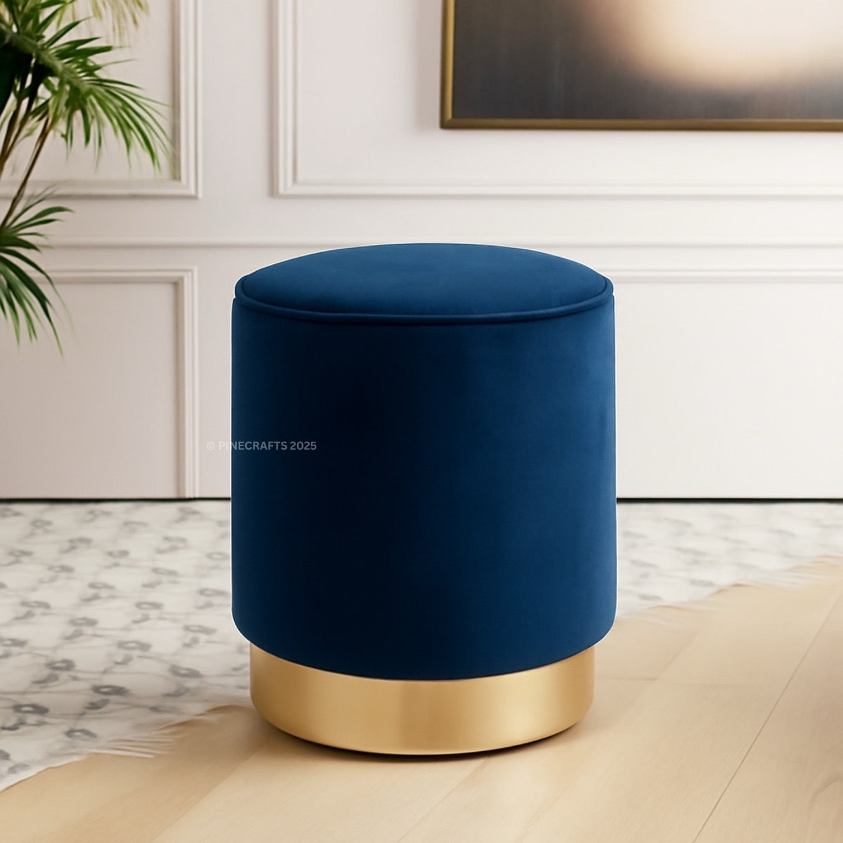 Blue ottoman with gold base in a room setting
