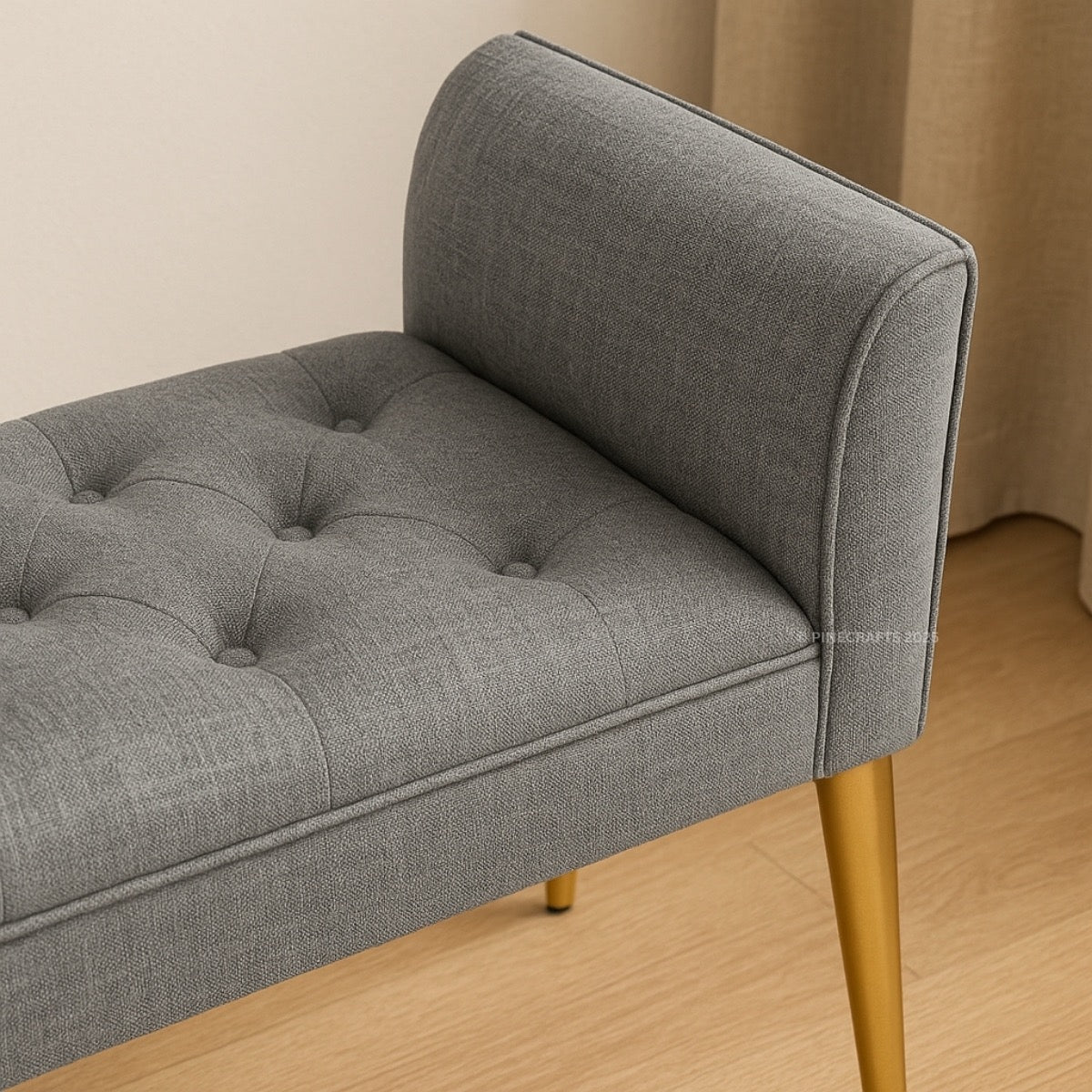 Gray upholstered bench with tufted seat on a wooden floor