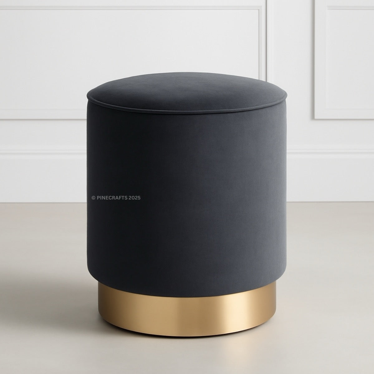 Gray ottoman with gold base on a light background