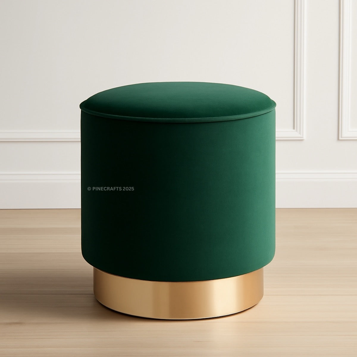 Green ottoman with gold base on a wooden floor