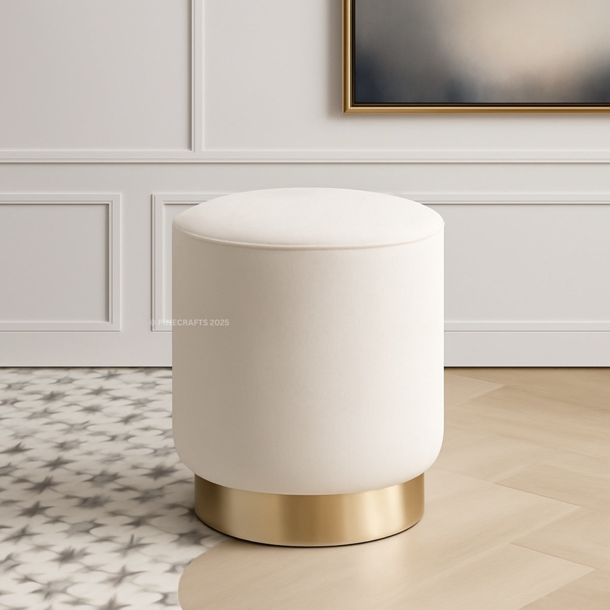 White ottoman with gold base in a room with decorative wall paneling.