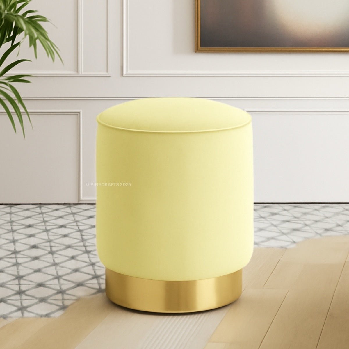 Yellow cylindrical lamp with gold base on a surface in a room setting