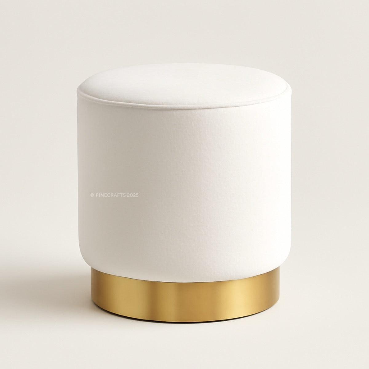 White ottoman with gold base on a light gray background
