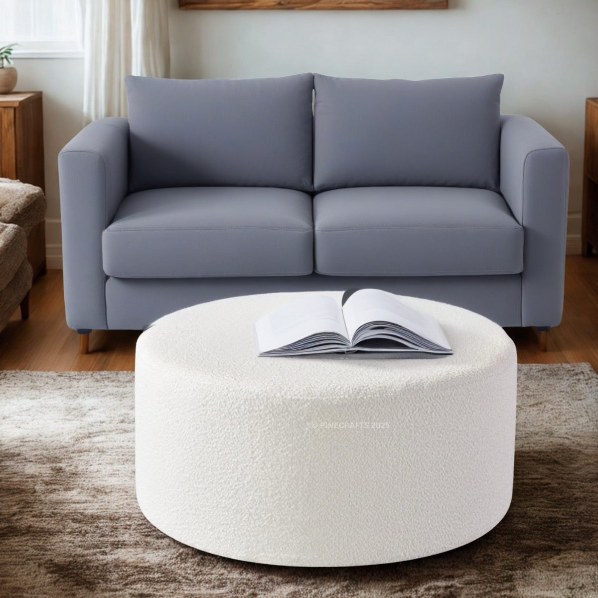 Gray sofa with a white ottoman in a living room setting