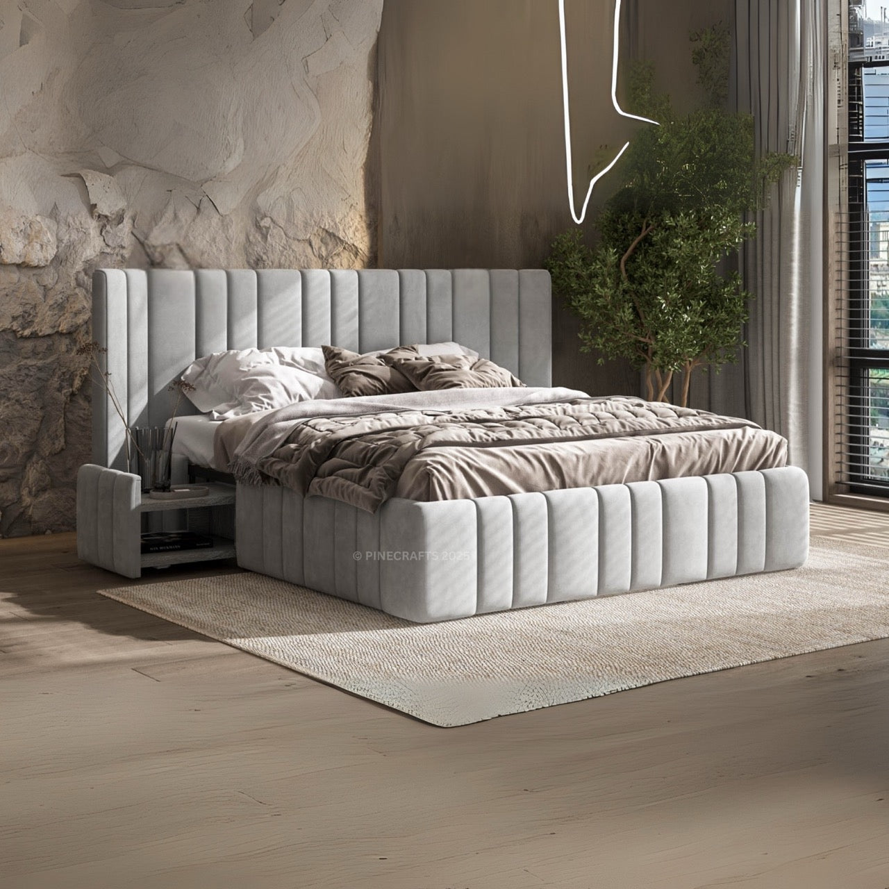 Gray upholstered bed in a modern bedroom with stone wall and plants.