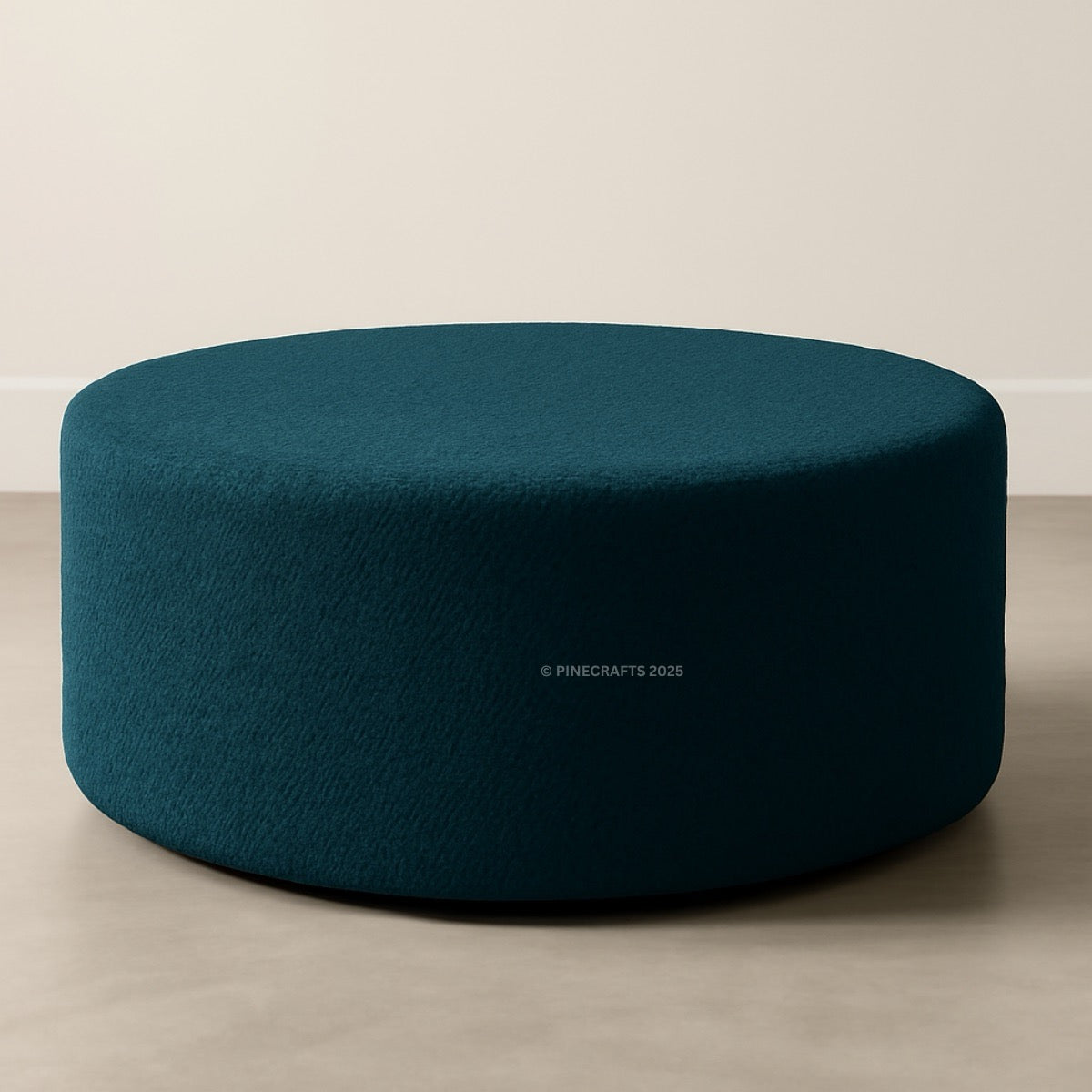 Teal ottoman on a beige floor with a neutral wall background