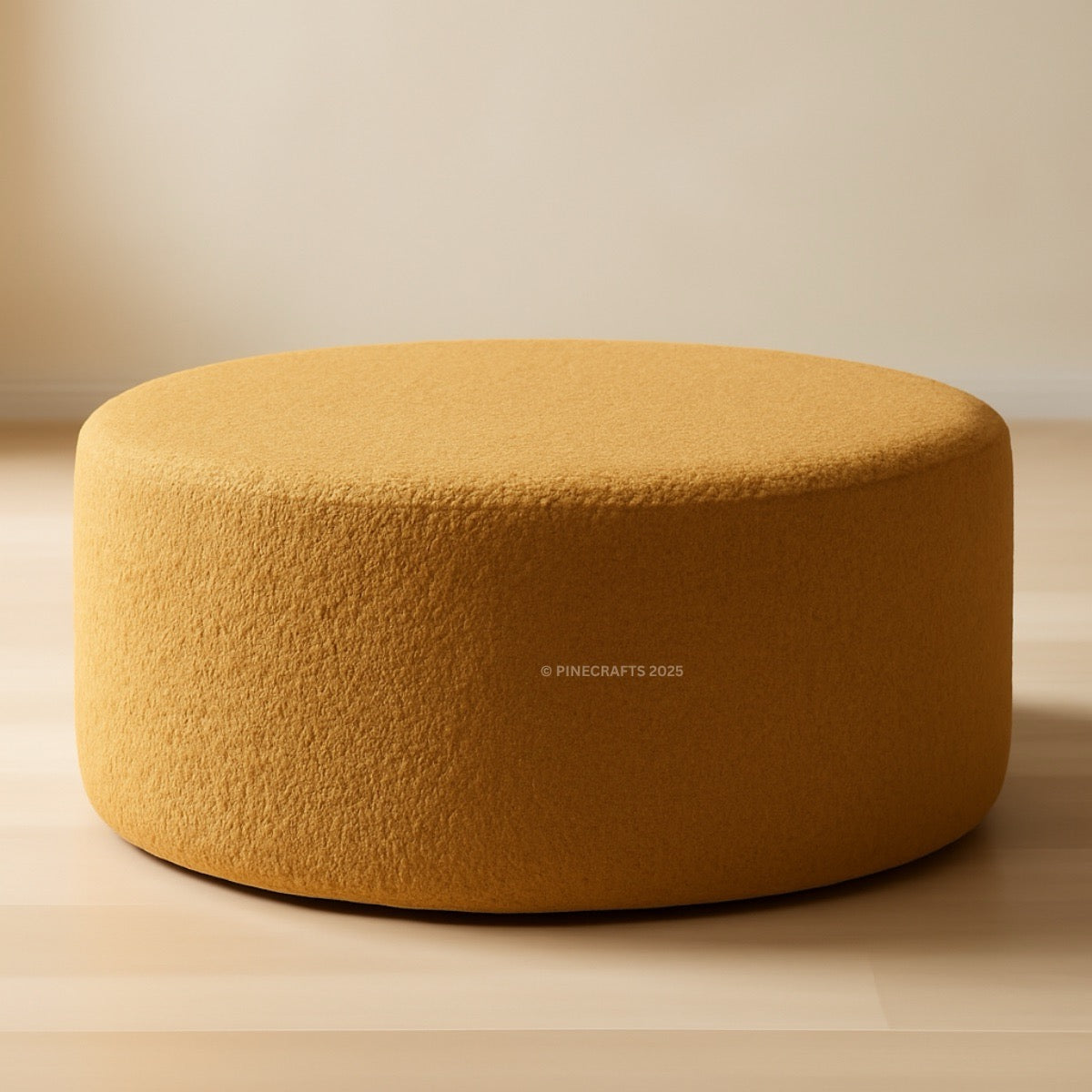 Round mustard yellow ottoman on a beige background