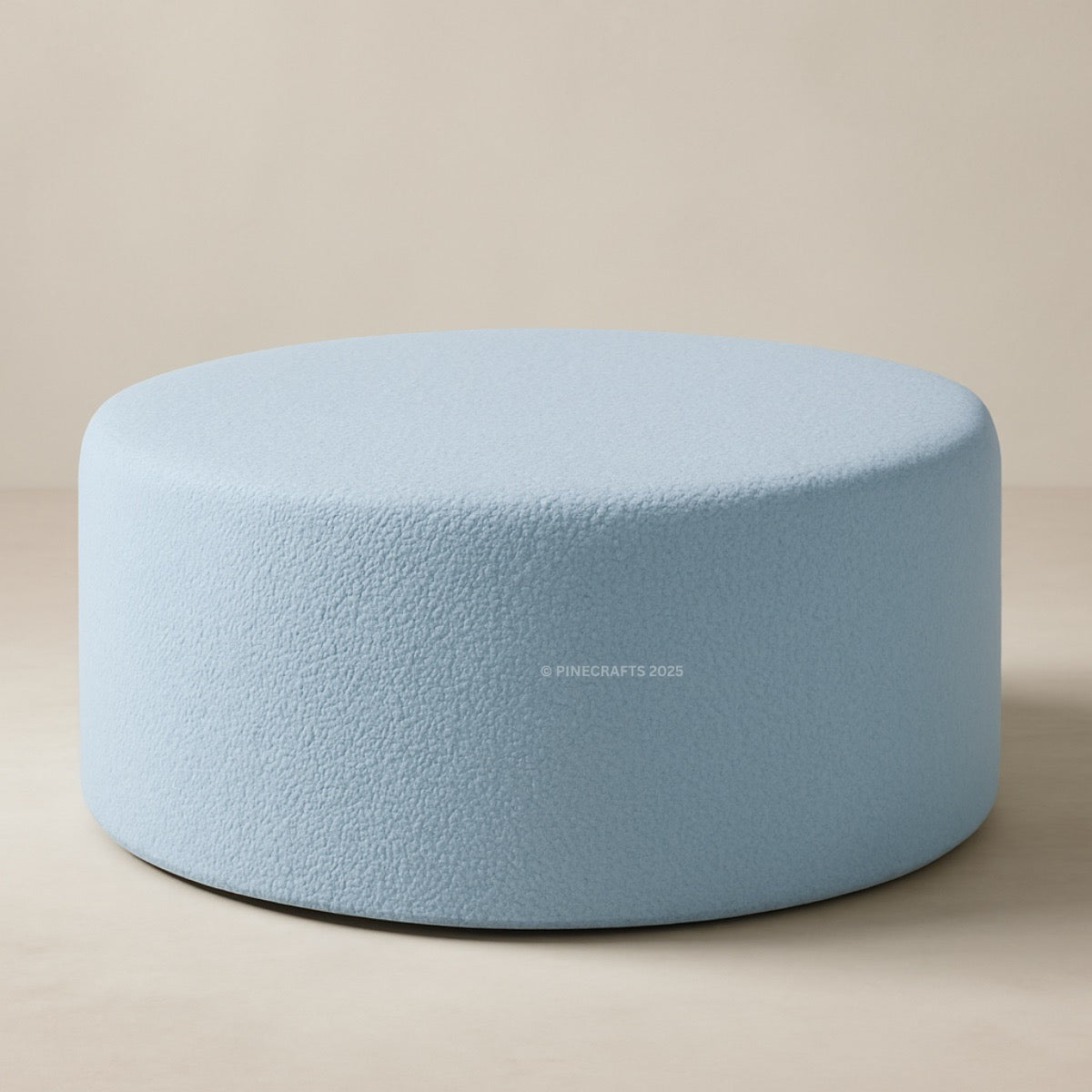 Round light blue cushion on a beige background