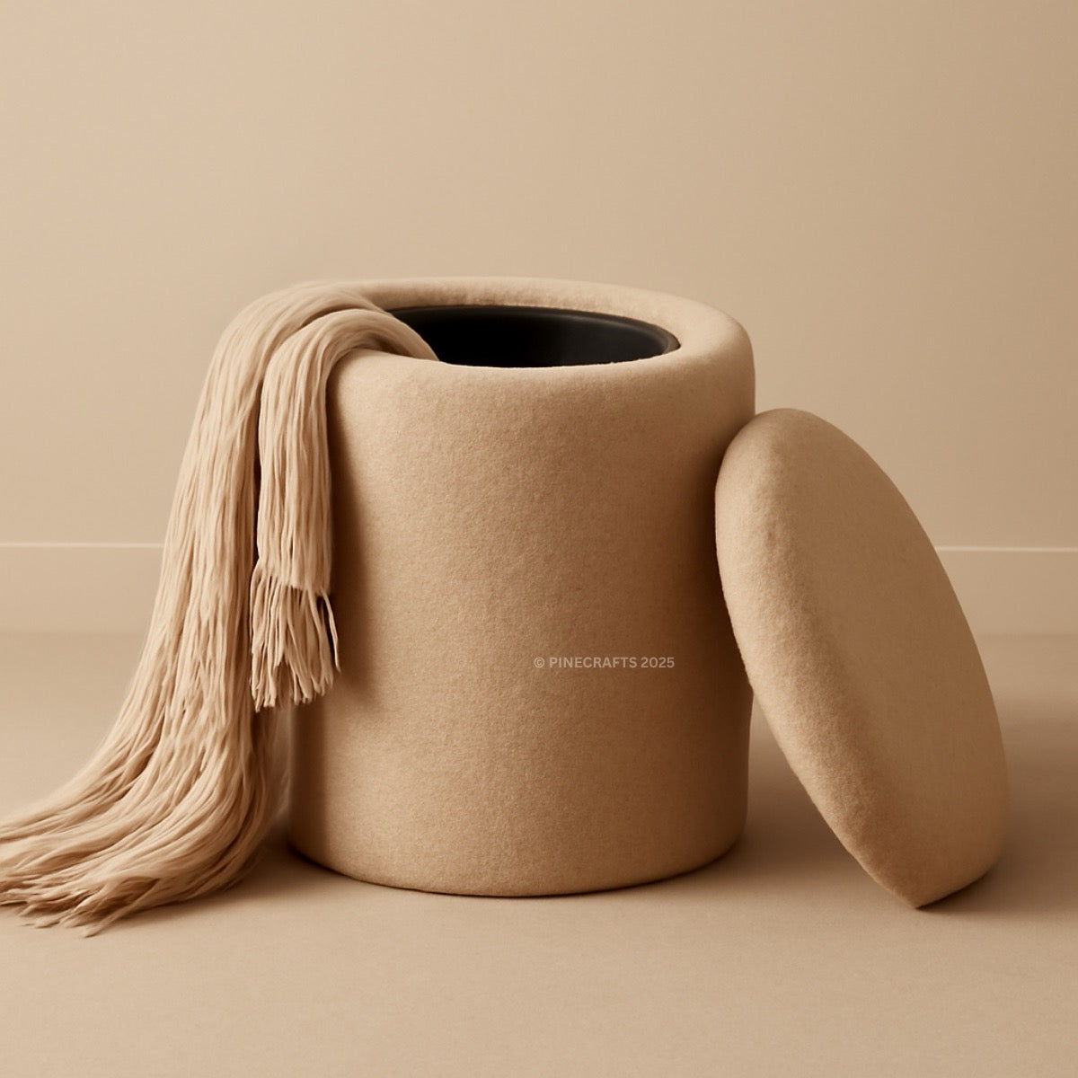 Beige woven basket with a beige scarf draped over it on a beige background