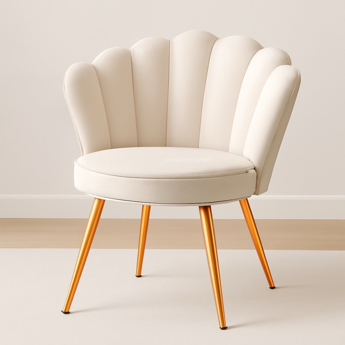 Beige armchair with scalloped backrest and gold legs on a plain background