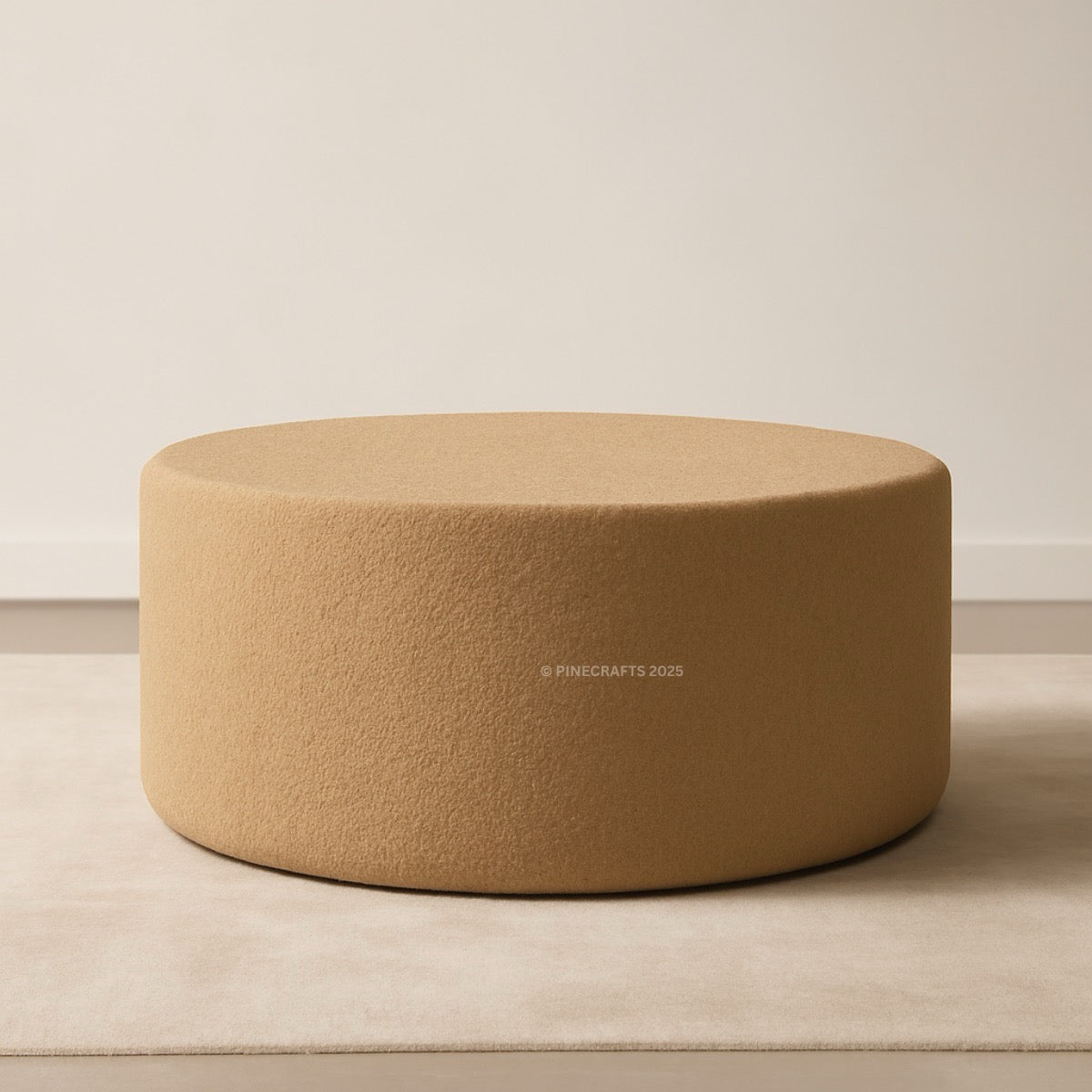 Round beige ottoman on a neutral background