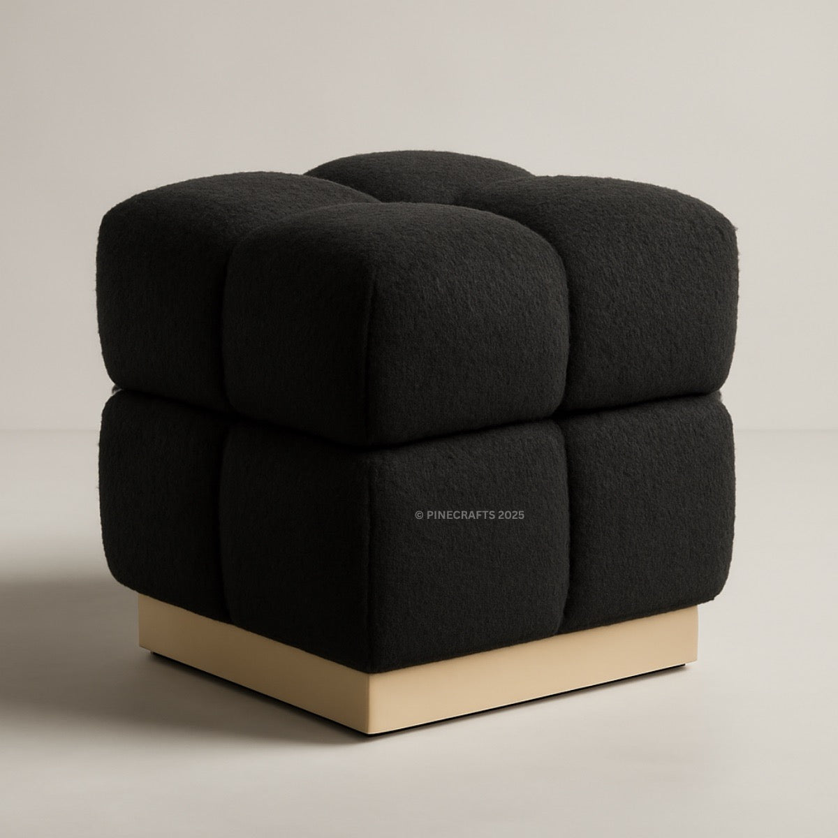 Black cube-shaped chair with a wooden base on a beige background