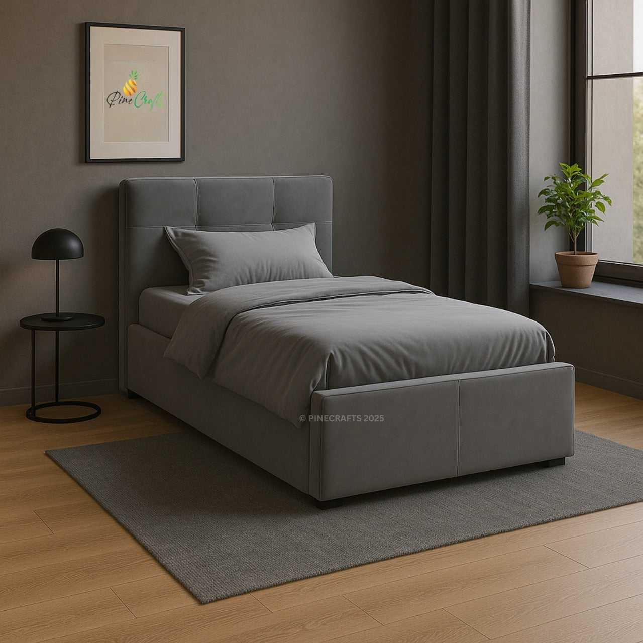 Gray upholstered bed in a room with a window, plant, and framed picture on the wall.