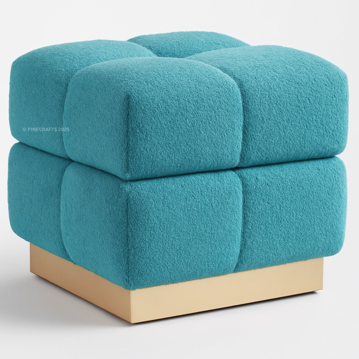 Teal cube-shaped ottoman with a gold base on a white background