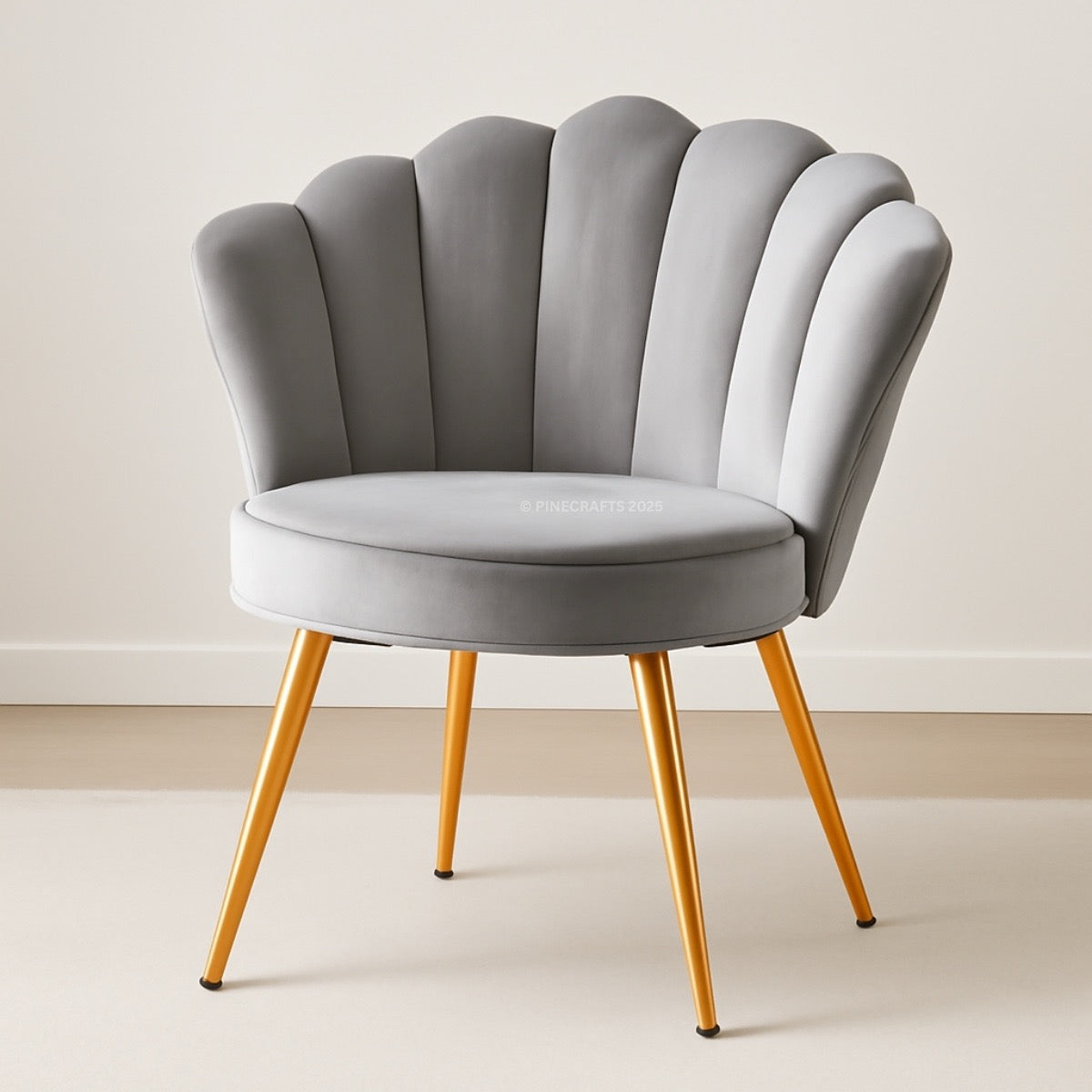 Gray shell-back chair with gold legs on a plain background