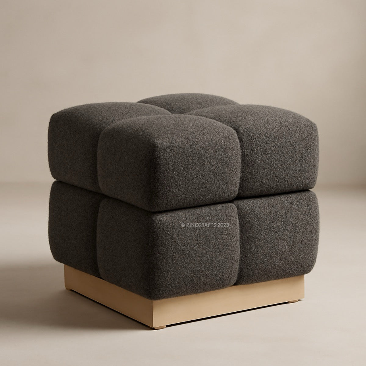 Gray textured ottoman with a wooden base on a beige background