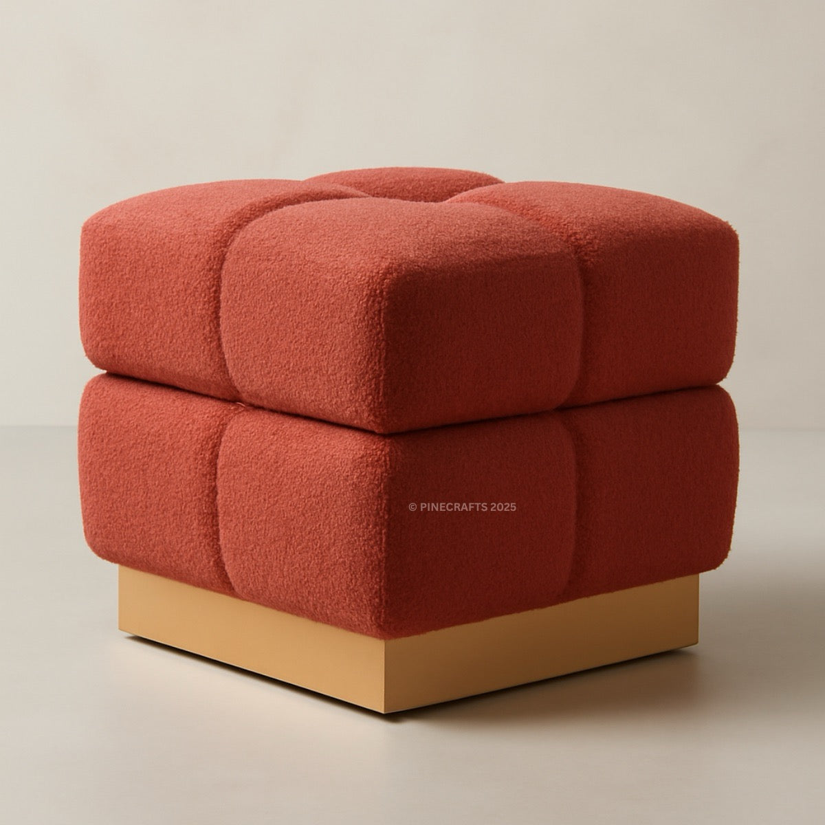 Red cube-shaped ottoman with a beige base on a neutral background