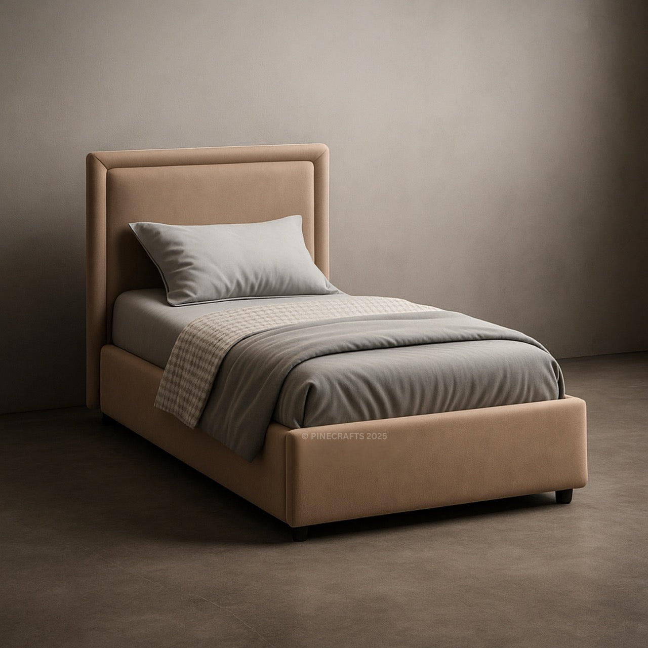 Beige bed with gray bedding against a plain wall