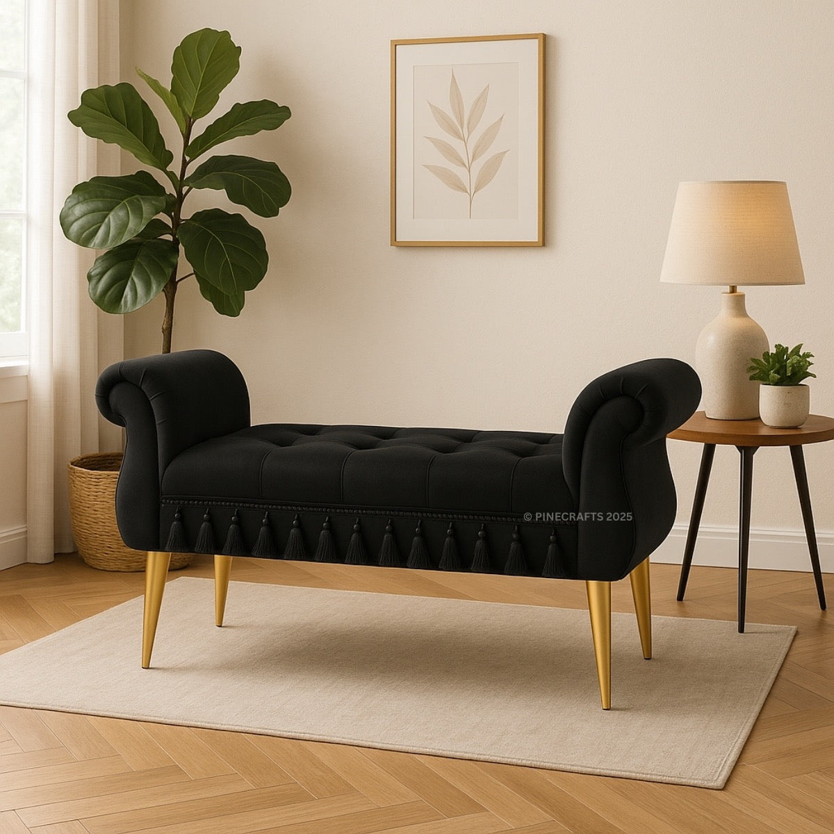 Black tufted bench with gold legs in a room with a plant, lamp, and wall art.