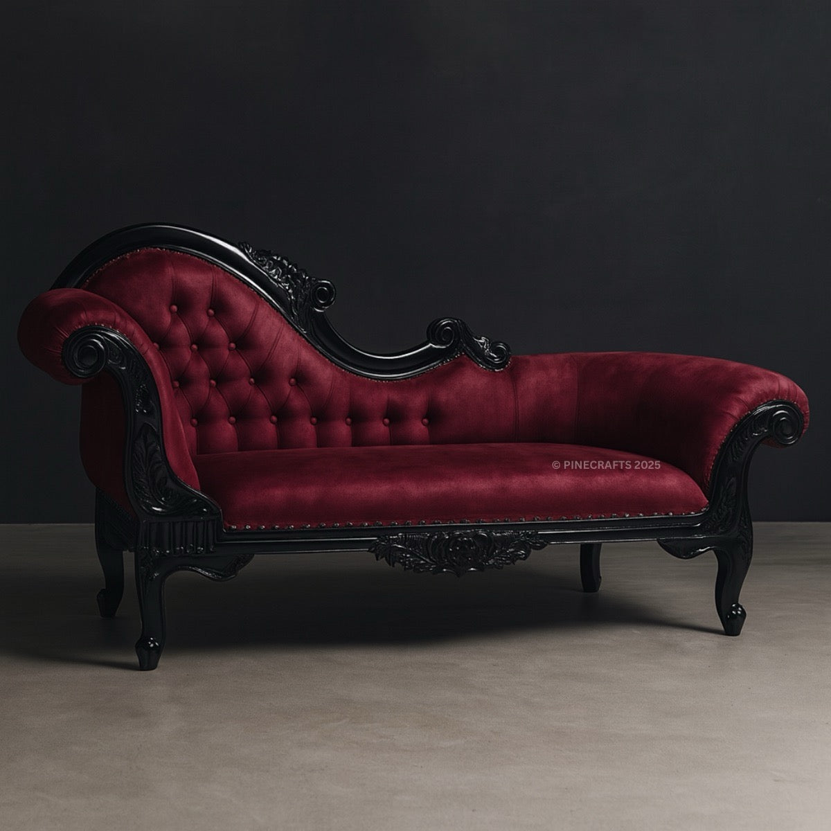 Red velvet chaise lounge with black frame on a dark background